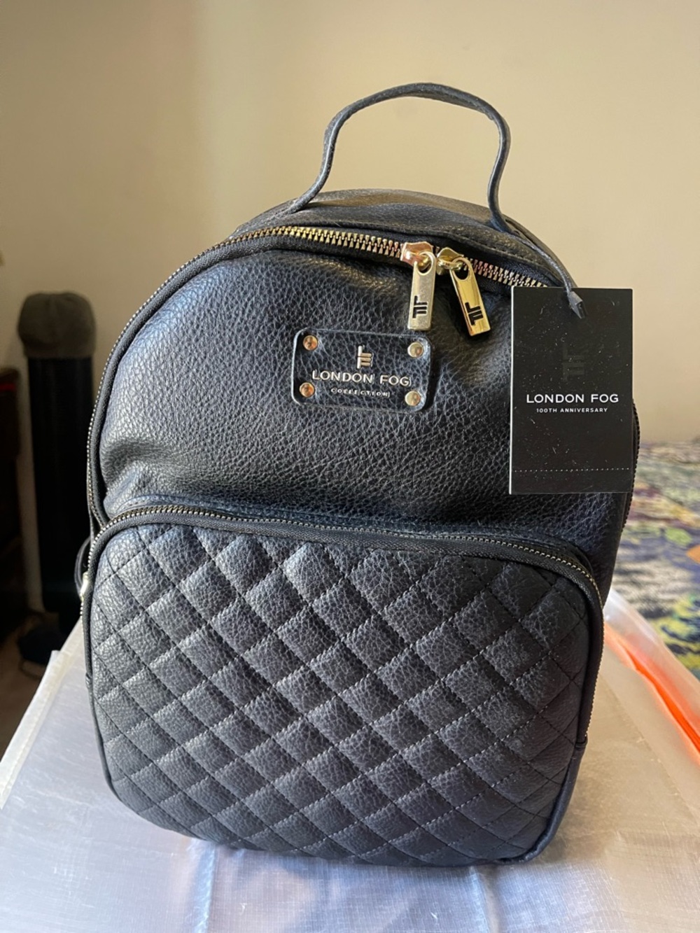 London Fog Black Quilted Nylon Backpack with Adjustable Straps and Gold Detail